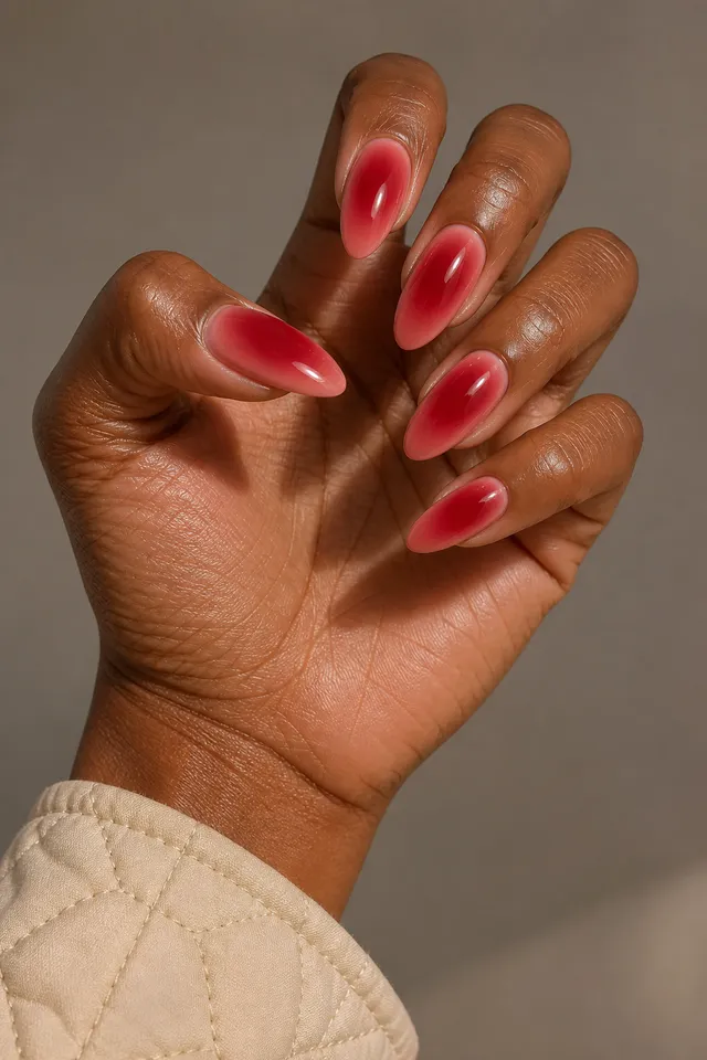 cherry chrome French tip nails on a medium olive hand with a visible forearm