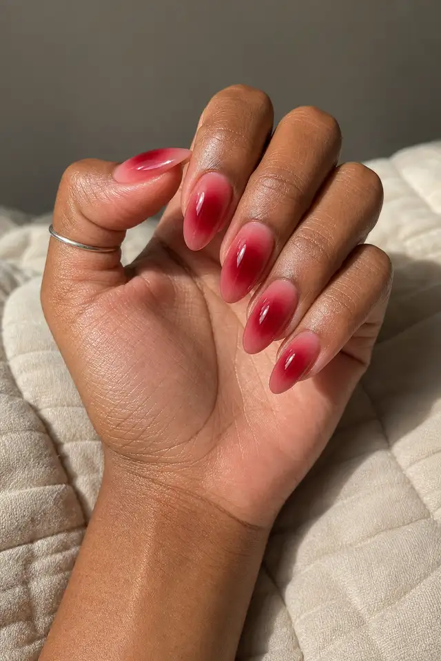 deep red glazed coffin nails on a deep brown hand with a connected wrist
