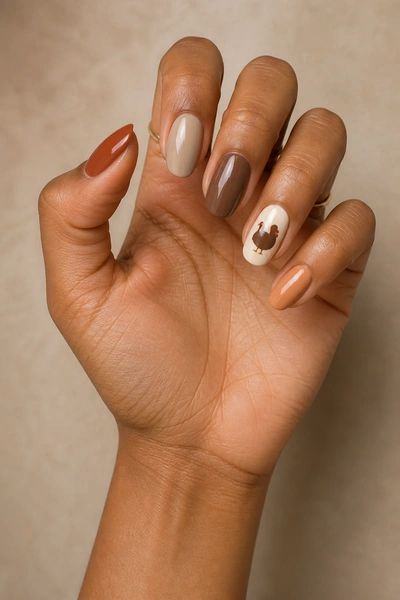 Warm nude turkey silhouette on medium oval nails with glossy finish, fingers angled toward the camera, light skin tone