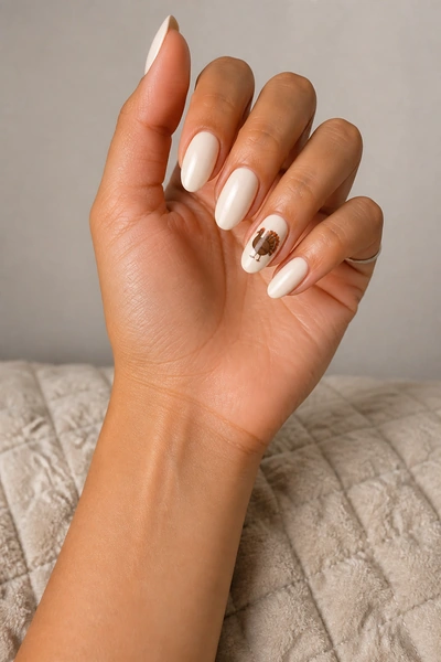 Blush nails with fine cocoa turkey line art on short oval shape, glossy daylight pose, medium skin tone