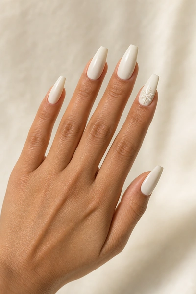 Ivory acrylic nails with raised snowflake detail on a palm and knuckle angle with visible forearm, light olive skin tone, natural daylight