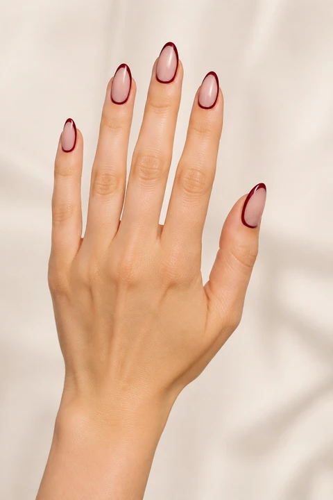 Cranberry turkey outline on medium almond nails with glossy finish, fingers angled forward, light skin tone
