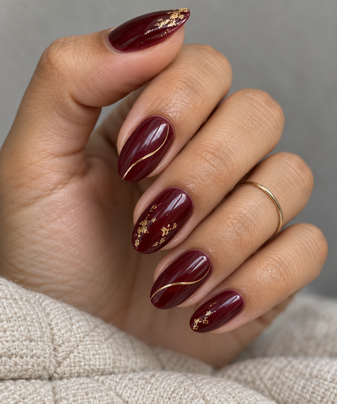 Gold over burgundy manicure